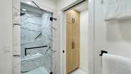 The shower features a steam option and a bench for convenience.