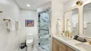 The guest master bathroom features a double vanity and a shower.