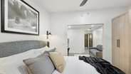 The upholstered king bed adds a touch of elegance to the space. 