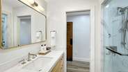 The single vanity offers additional counter space and drawers for unpacking toiletries.