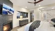 ...a gas fireplace, and a TV. The bedroom flows right into the gorgeous master bathroom.
