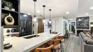 The kitchen island offers additional seating for 3 at the bar. From here you can easily access the guest master bedroom.