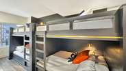 Each bunk is elevated with a reading lamp.