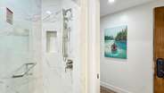 ...a shower with a bench and steam option,...