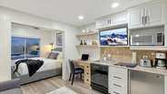There is a custom built-in desk where you can work. The kitchenette includes a sink, mini fridge, microwave, dishwasher, and 2-burner electric stovetop, and TV.