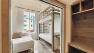 Another full lock-off suite with a queen bed, twin over twin bunks, living room, kitchenette, and bathroom