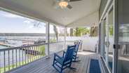 Porch with hot tub in the background