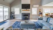 Living room with gas fireplace and glass doors to the lake