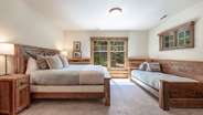 Downstairs king suite with additional twin bed, attached bathroom, and gas fireplace