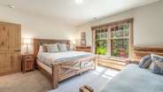 Downstairs king suite with additional twin bed, attached bathroom, and gas fireplace