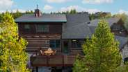 Spacious back deck off the main level with outdoor dining area and grill