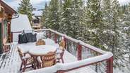 Spacious back deck off the main level with outdoor dining area and grill