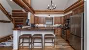 Fully equipped kitchen with barstool seating for 3 guests 