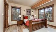Primary suite on main level with fireplace, attached bathroom, and deck access