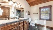 Upstairs king suite bathroom with double vanity, jet tub, and walk-in shower