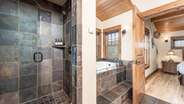 Upstairs king suite bathroom with double vanity, jet tub, and walk-in shower