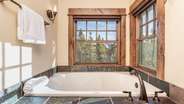Upstairs king suite bathroom with double vanity, jet tub, and walk-in shower