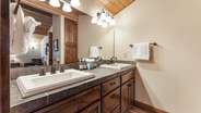 Upstairs queen suite bathroom with double vanity and walk-in shower