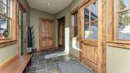Side entry way with hooks for ski gear, benches and boot dryers